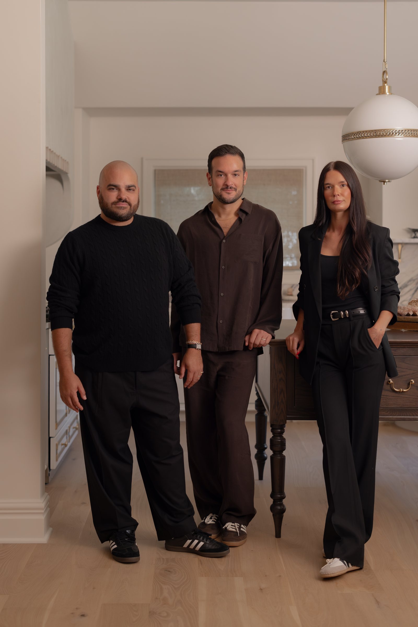 The HIM&HIS Design team standing together in the kitchen of a recently finished house